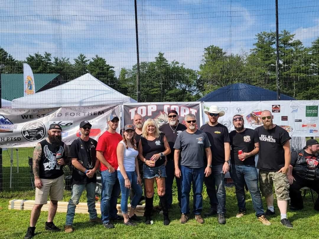 Group photo of riders and volunteers at an event